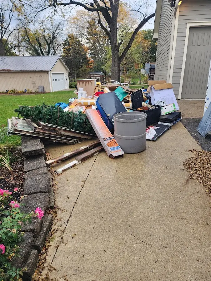 Dumpster being loaded with debris for 10 Yard Dumpster Rental in Byram